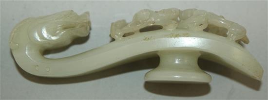 A Chinese white jade dragon belt hook, 18th century, 10cm, slight losses to chi-dragons, later piercings